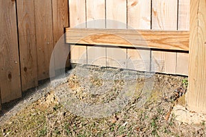 Chicken wire on a fence.