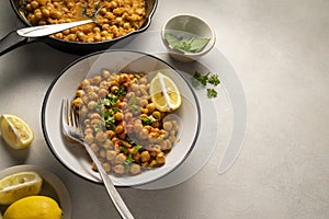 Chickpea dish with curry, cooked chickpeas with spices and herbs. Vegetarian food, copy space.