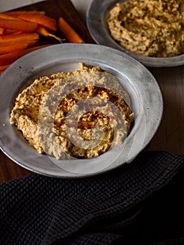 Chickpea hummus home made in natural light on farm table