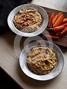 Chickpea hummus home made in natural light on farm table