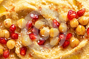 Chickpea hummus with tahini and pomegranate. Healthy vegetarian appetizer. Middle Eastern cuisine