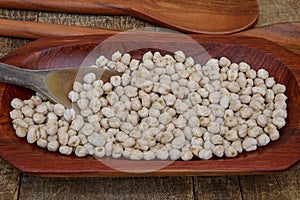 Chickpea portion on red wood platter