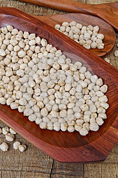 Chickpea portion on red wood platter