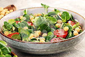 Chickpea salad with ingredient and tomatoes and lambÂ´s lettuce. healthy salad