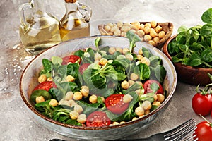 Chickpea salad with ingredient and tomatoes and lambÂ´s lettuce. healthy salad