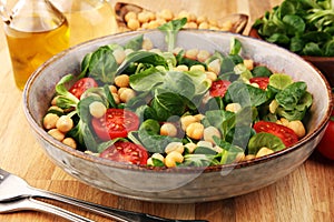 Chickpea salad with ingredient and tomatoes and lambÂ´s lettuce. healthy salad