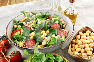 Chickpea salad with ingredient and tomatoes and lambÂ´s lettuce. healthy salad