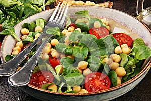 Chickpea salad with ingredient and tomatoes and lambÂ´s lettuce. healthy salad