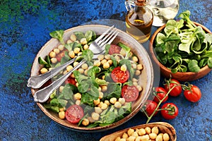 Chickpea salad with ingredient and tomatoes and lambÂ´s lettuce. healthy salad