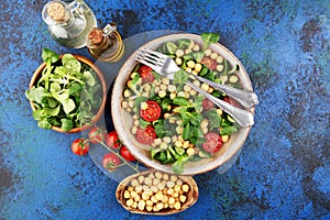Chickpea salad with ingredient and tomatoes and lambÂ´s lettuce. healthy salad