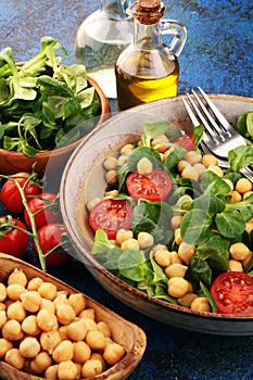 Chickpea salad with ingredient and tomatoes and lambÂ´s lettuce. healthy salad