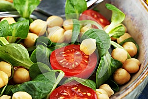 Chickpea salad with ingredient and tomatoes and lambÂ´s lettuce. healthy salad