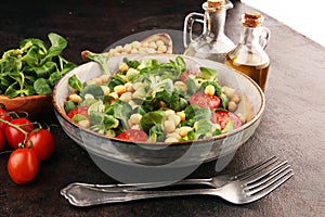 Chickpea salad with ingredient and tomatoes and lambÂ´s lettuce. healthy salad