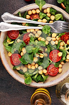 Chickpea salad with ingredient and tomatoes and lambÂ´s lettuce. healthy salad