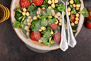 Chickpea salad with ingredient and tomatoes and lambÂ´s lettuce. healthy salad