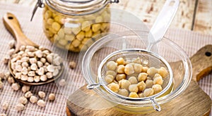 Chickpeas being sieved to extract aquafaba, cooking liquid used as an alternative to egg whites