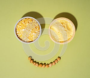 Chickpeas cereal and flour in small ceramic plates bowl isolated on green olive background. vegetarian dish.
