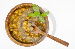 Chickpeas with curry sauce in wooden bowl. Studio Photo