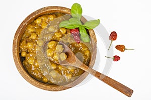 Chickpeas with curry sauce in wooden bowl. Studio Photo