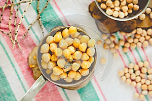 Chickpeas dry and boiled in an iron bowl, thyme. Rustik style background. Top view.