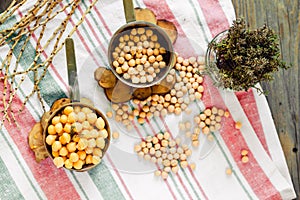 Chickpeas dry and boiled in an iron bowl, thyme. Rustik style background. Top view.