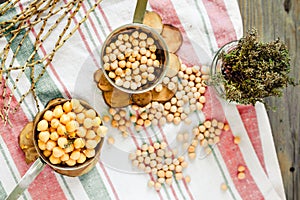 Chickpeas dry and boiled in an iron bowl, thyme. Rustik style background. Top view.