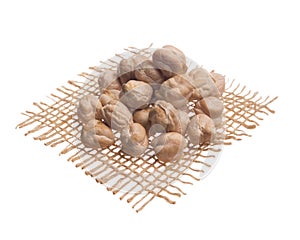 Chickpeas. Grains over hessian fabric, isolated white background photo