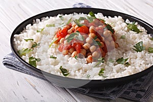 Chickpeas in tomato sauce with rice close-up. Horizontal