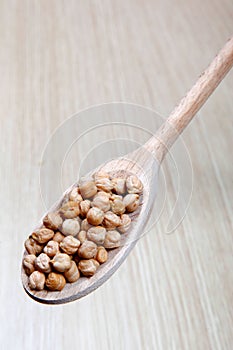 Chickpeas, vegetables on a wooden spoon