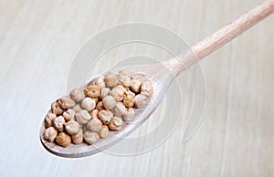 Chickpeas, vegetables on a wooden spoon