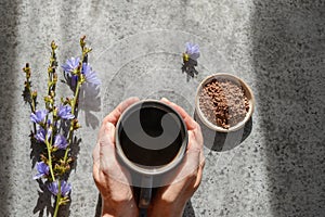 Chicory drink and flowers. Healthy herbal beverage, coffee substitute. Top view.