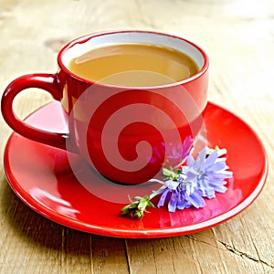Chicory drink in red cup with flower on board