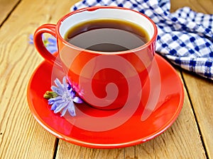 Chicory drink in red cup with napkin and flower