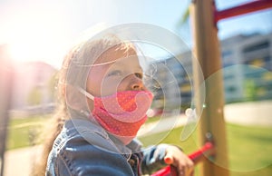 Chidren with a face mask on playground