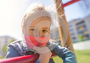 Chidren with a face mask on playground