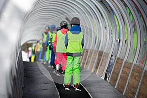 Chidren in ski school on conveyor belt