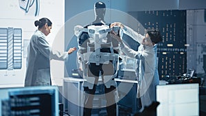 Chief Analyst Uses Computer, Female Engineer and Top Male Scientist Work on a Bionics Exoskeleton