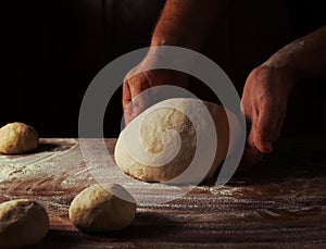 Chief baker preparing dough for bread in a bakery. Kitchen professional