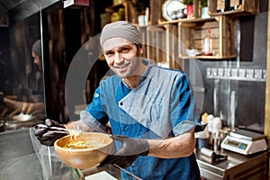 Chief cook at the asian restaurant kitchen