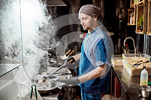 Chief cook cooking at the asian kitchen