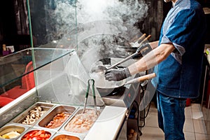 Chief cook cooking at the asian kitchen