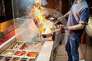 Chief cook cooking at the asian kitchen