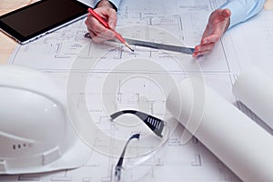 Chief engineer or architect works with building drawings