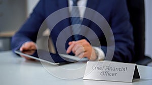 Chief financial officer of corporation using tablet pc, planning company budget