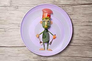 Chief made of cucumbers on purple plate