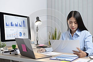 Chief marketing officer in Asia is analyzing the company`s financial growth graph using personal computers for work