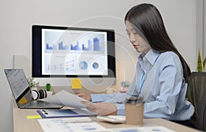 Chief marketing officer in Asia is analyzing the company`s financial growth graph using personal computers for work