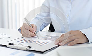 Chief marketing officer in Asia is analyzing the company`s financial growth graph using personal computers for work