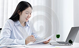 Chief marketing officer in Asia is analyzing the company`s financial growth graph using personal computers for work