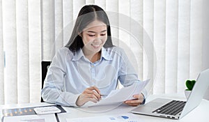 Chief marketing officer in Asia is analyzing the company`s financial growth graph using personal computers for work